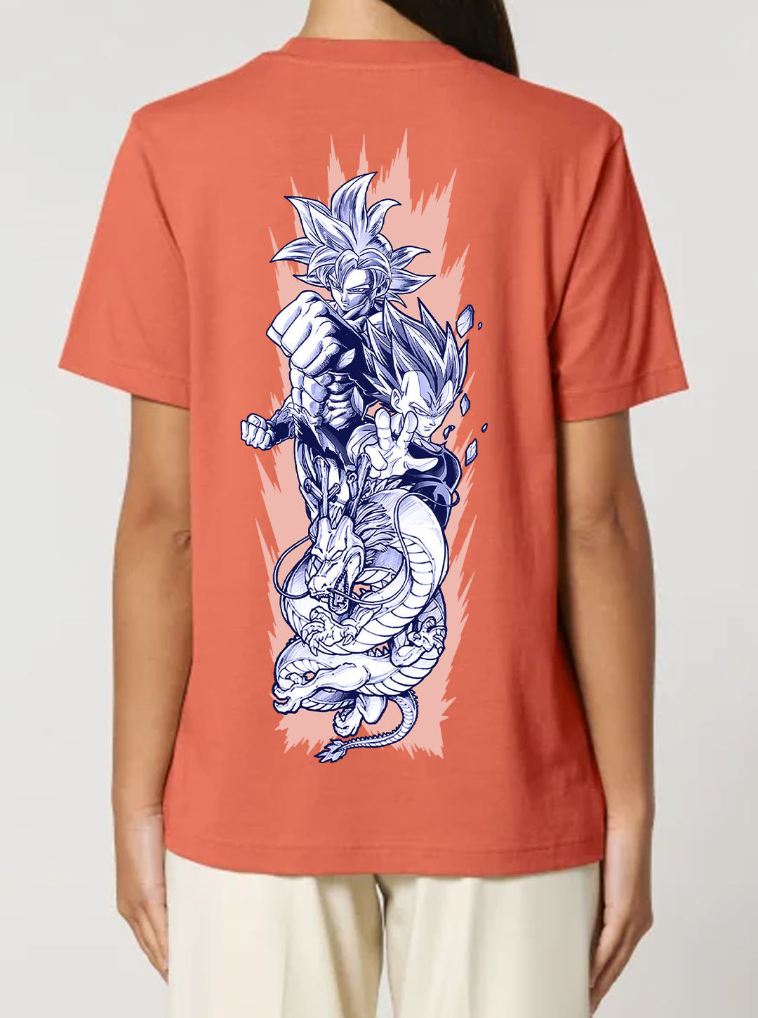 Orange t-shirt featuring the Goku, Vegeta and Shenron prints in blue and white on front and back, made from 100% organic breathable cotton, with an oversized fit when sized up.